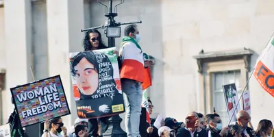 Photograph of protesters carrying signs such as “Women, Life, Freedom” in support of women and human rights in Iran. 