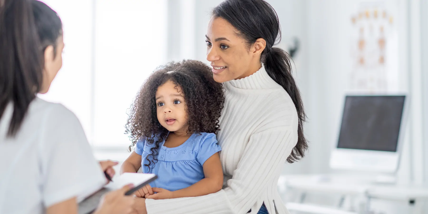 Young mom with toddler getting medical check up
