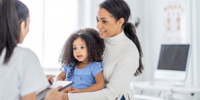 Young mom with toddler getting medical check up