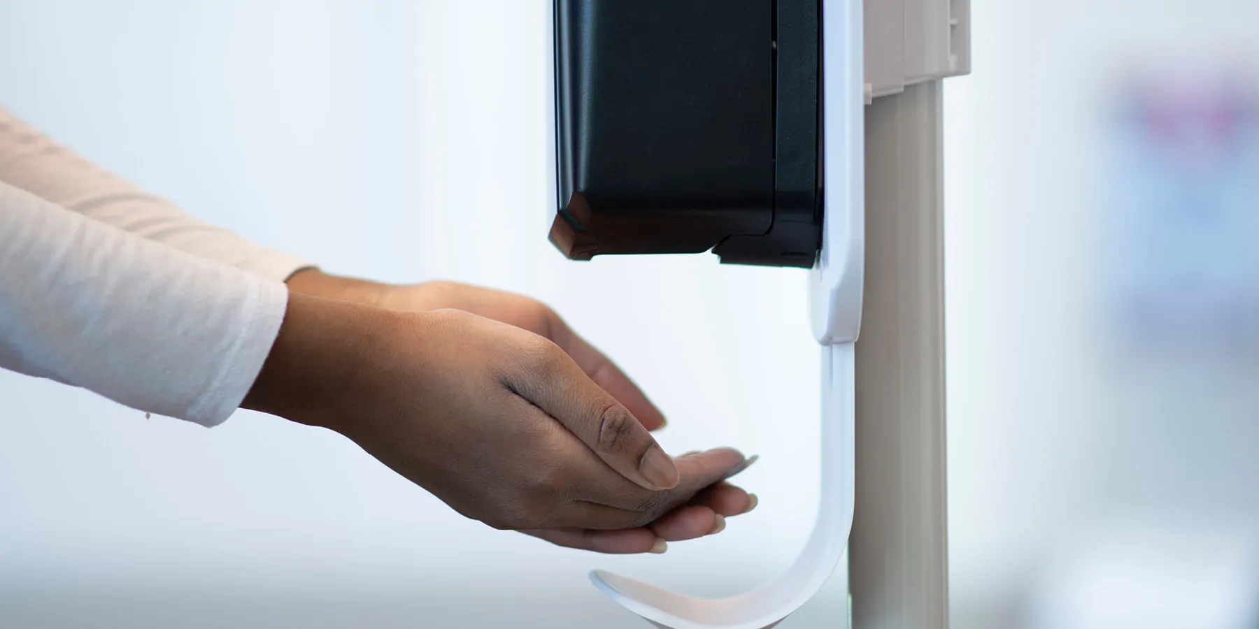 Women using a hand sanitizer