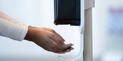 Women using a hand sanitizer