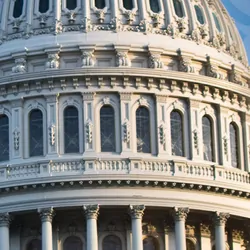 Photo of the US Congress on a background with US dollar bills.