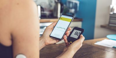 Women checking her blood sugar on her phone