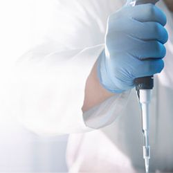 Scientist using pipette