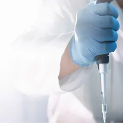 Scientist using pipette