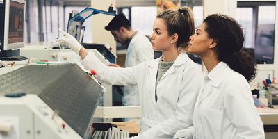 Clinical professionals analyzing liquid sample