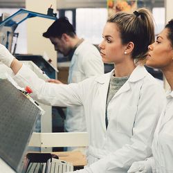 Clinical professionals analyzing liquid sample