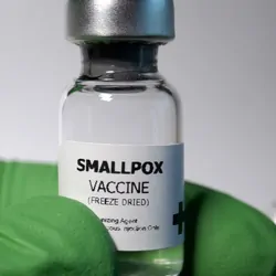 Gloved hand holding a bottle of smallpox vaccine