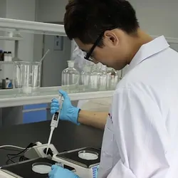 Molecular biology scientist using pipette