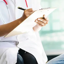 Female doctor asks questions about cancer patient