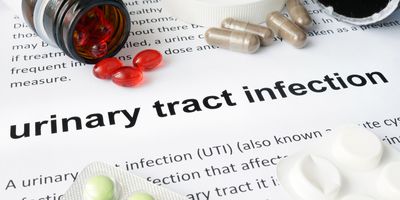 Document about UTI with pills spilled on it