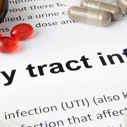 Document about UTI with pills spilled on it