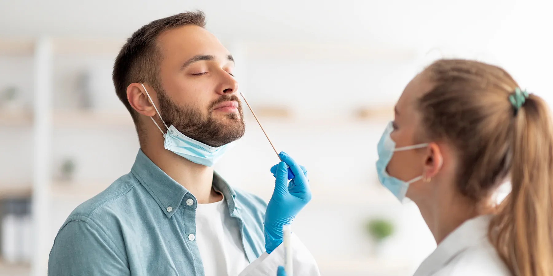 Man getting a nasal swab done by a medical professional