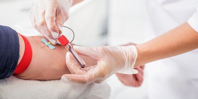 Medical professional drawing blood from a patient for testing