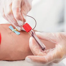 Medical professional drawing blood from a patient for testing