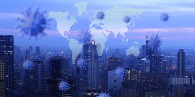 Double exposure of a city and a map of the world with viral particles around