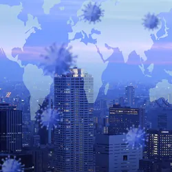 Double exposure of a city and a map of the world with viral particles around