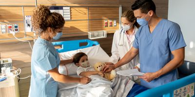 Doctors standing around a sick child in the hospital