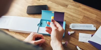 Photo of a clinical trial participant taking a self-collection blood sample.