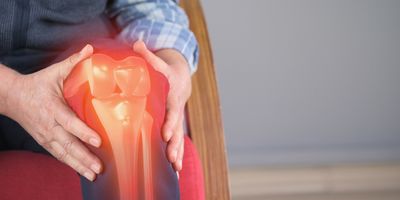 Man with knee pain, computer image of knee join is visible