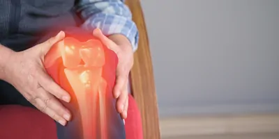 Man with knee pain, computer image of knee join is visible