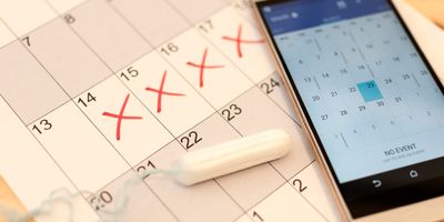 Photo of a calendar with red x’s marking menstrual cycle.