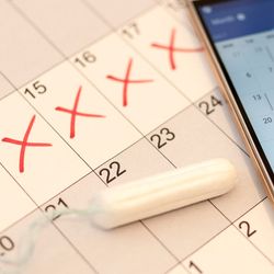Photo of a calendar with red x’s marking menstrual cycle.