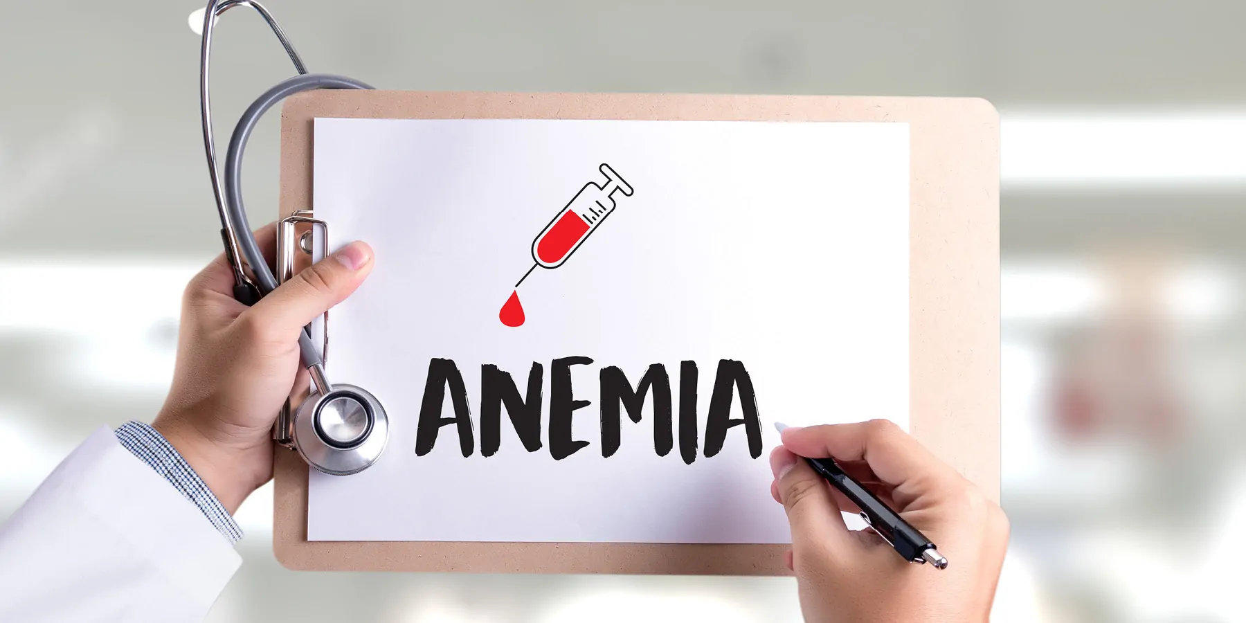 A person holding a clipboard with a paper having the word anemia written
