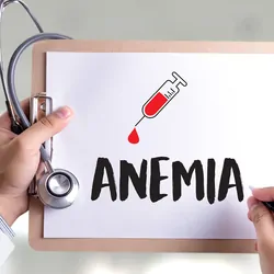 A person holding a clipboard with a paper having the word anemia written