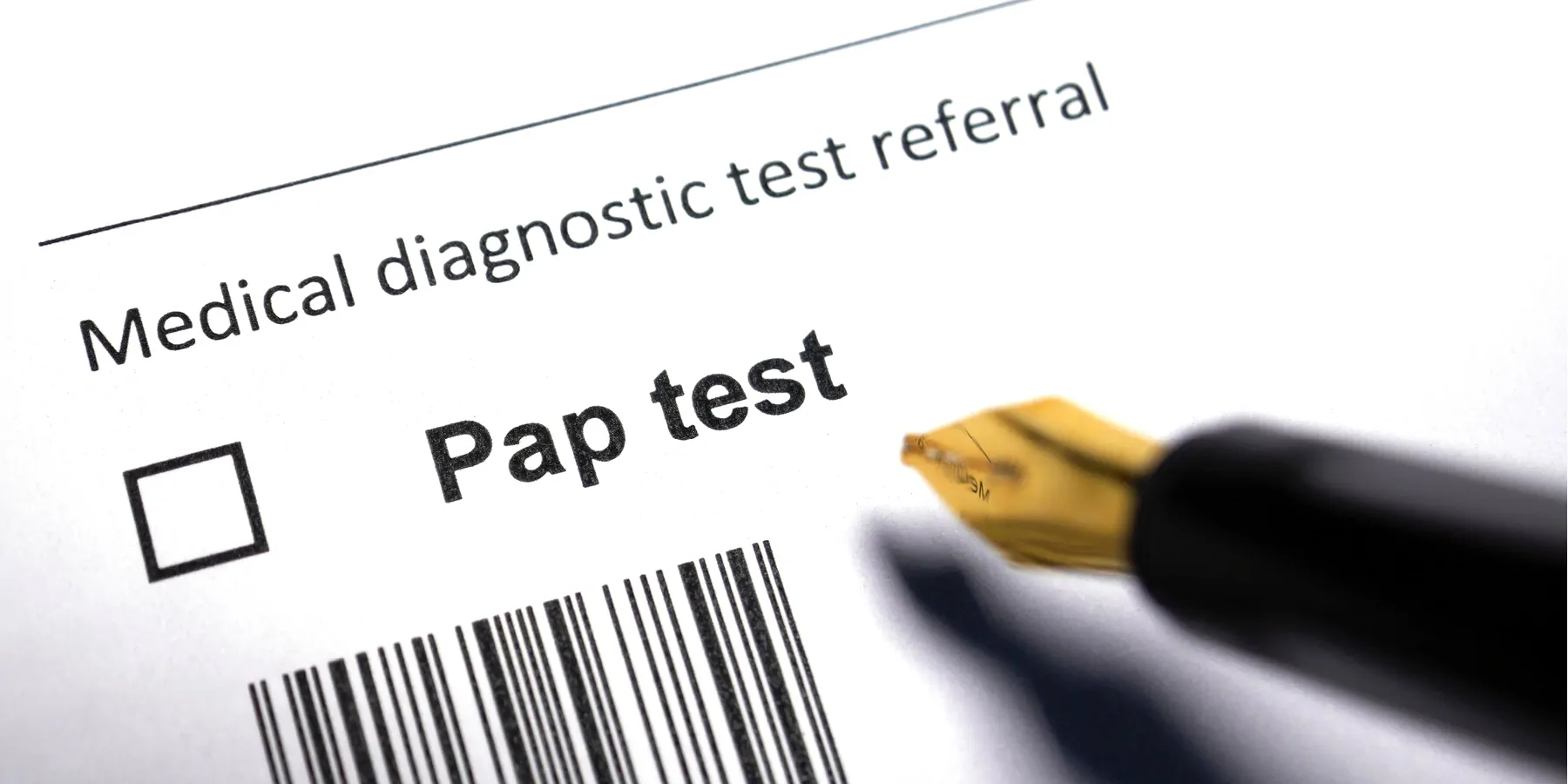 A close-up of a Medical diagnostic test referral form for Pap test  and a bar code