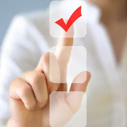 A silhouette of a woman checking off a box on a touch screen to symbolize survey on automated flow cytometry.
