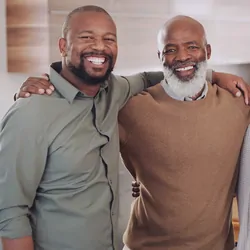 Cropped portrait of a happy family standing with their arms around each other in their home