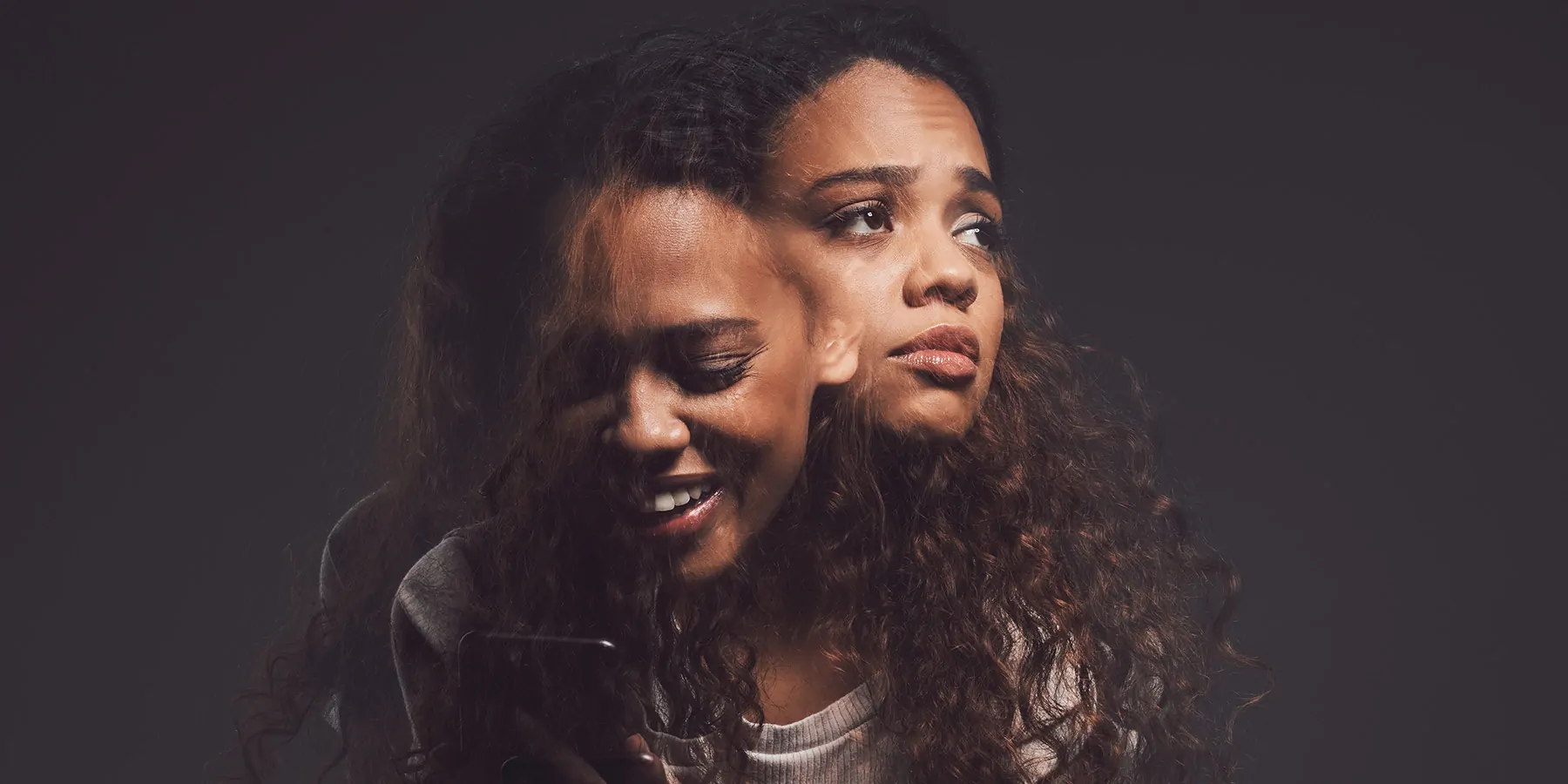 Studio shot of a young woman experiencing mental anguish and screaming against a black background