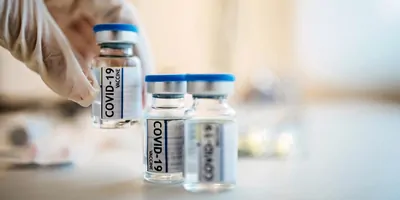 A clinician lifts a Covid-19 vaccine vials