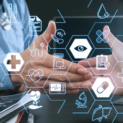 Doctor and patient shaking hands in modern office at hospital