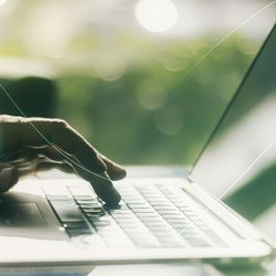 Laptop open with DNA strand 