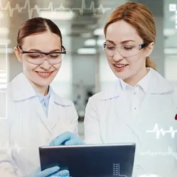 Clever enthusiastic positive doctors feeling glad while standing in their modern equipped laboratory and looking at the screen of a tablet
