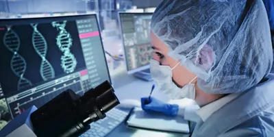 A female scientist examines DNA models in genetics research laboratory.