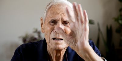 Senior man looking at camera saying stop no more.