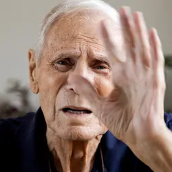 Senior man looking at camera saying stop no more.