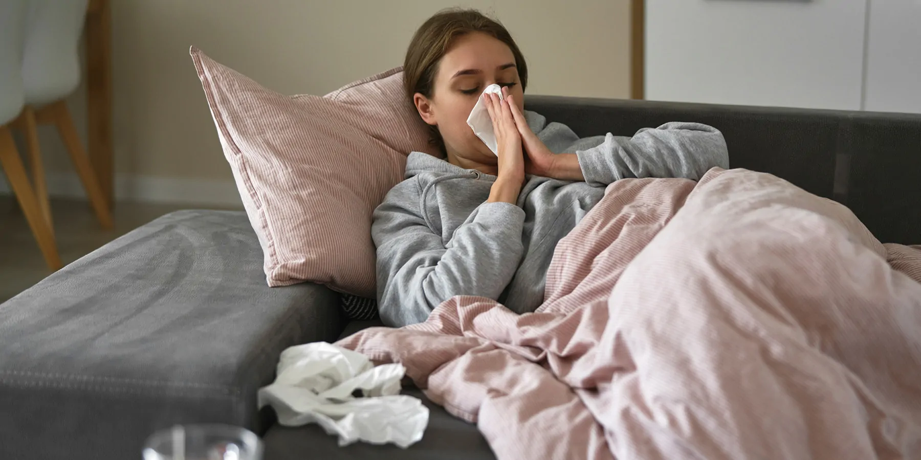 Phase 1 Trial of mRNA Universal Influenza Vaccine Candidate Begins Caucasian woman lying on sofa with flu at home