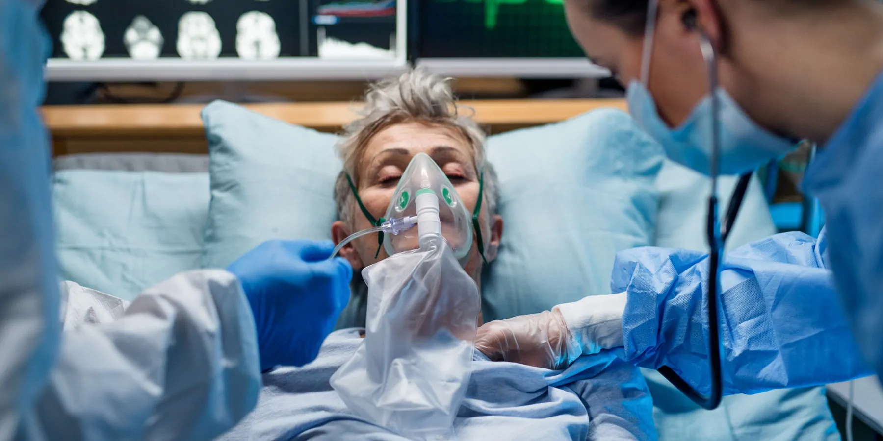 An infected patient in quarantine lying in bed in a hospital on a ventilator.