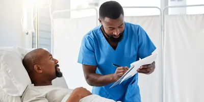 Healthcare professional consulting with a sick man about a drug trial for cancer