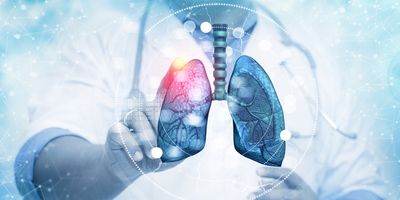 A clinician touching a digital rendering of human lungs on blurred background