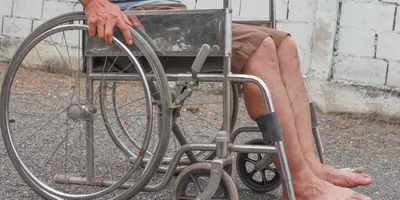 A male using a wheelchair on a street