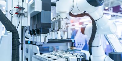 A multi-stage laboratory robot loads equipment in a blue and white themed image of a modern laboratory.