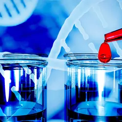 A glass dropper adds a big drop of red liquid to filled test tubes against a background of a graphical illustration of DNA double helices.
