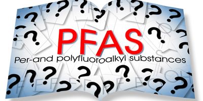 An opened book with PFAS written on it and surrounded with question marks.