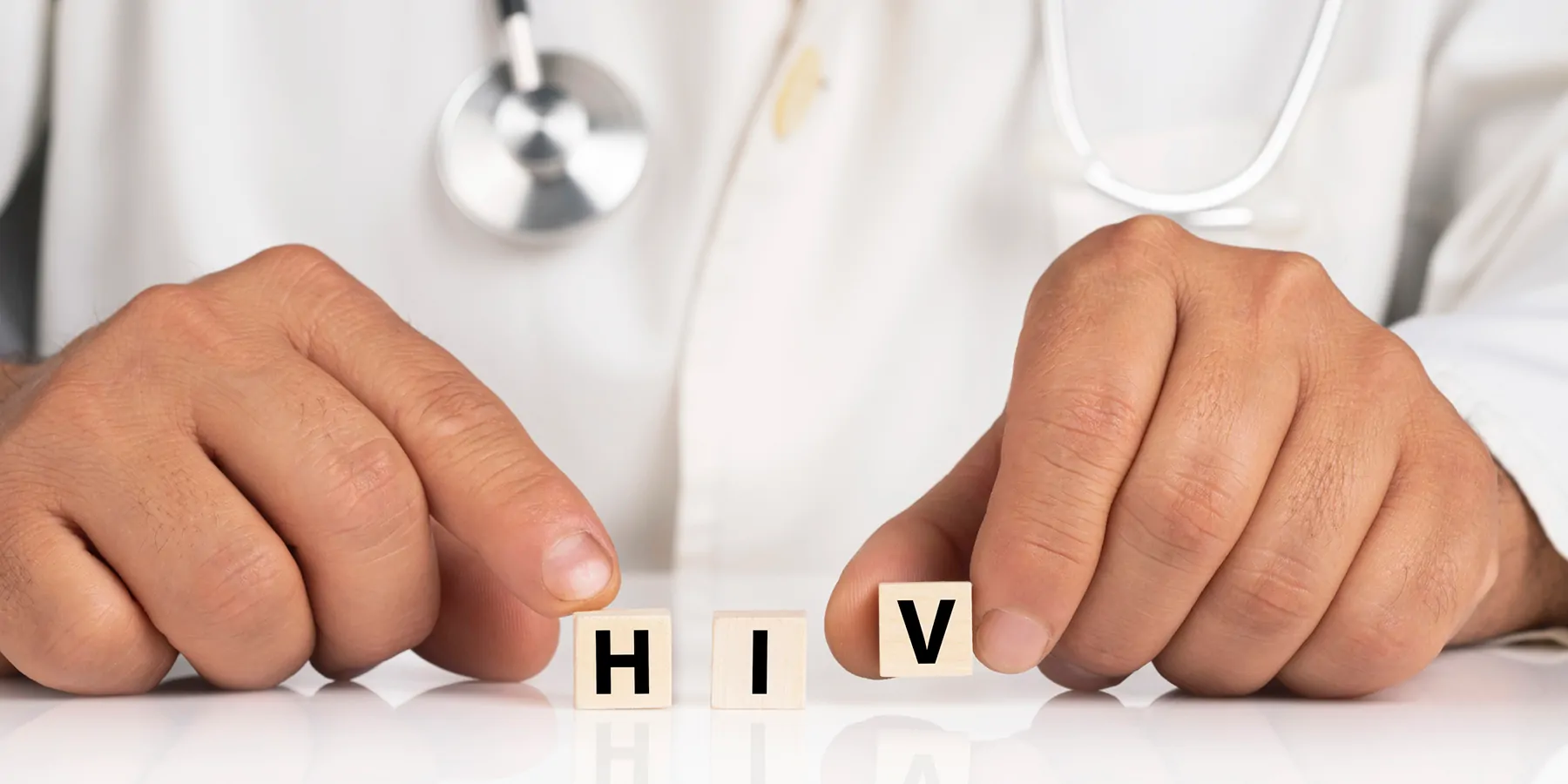 A clinician shows cubes with text HIVA clinician shows cubes with text HIV