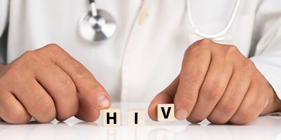 A clinician shows cubes with text HIVA clinician shows cubes with text HIV